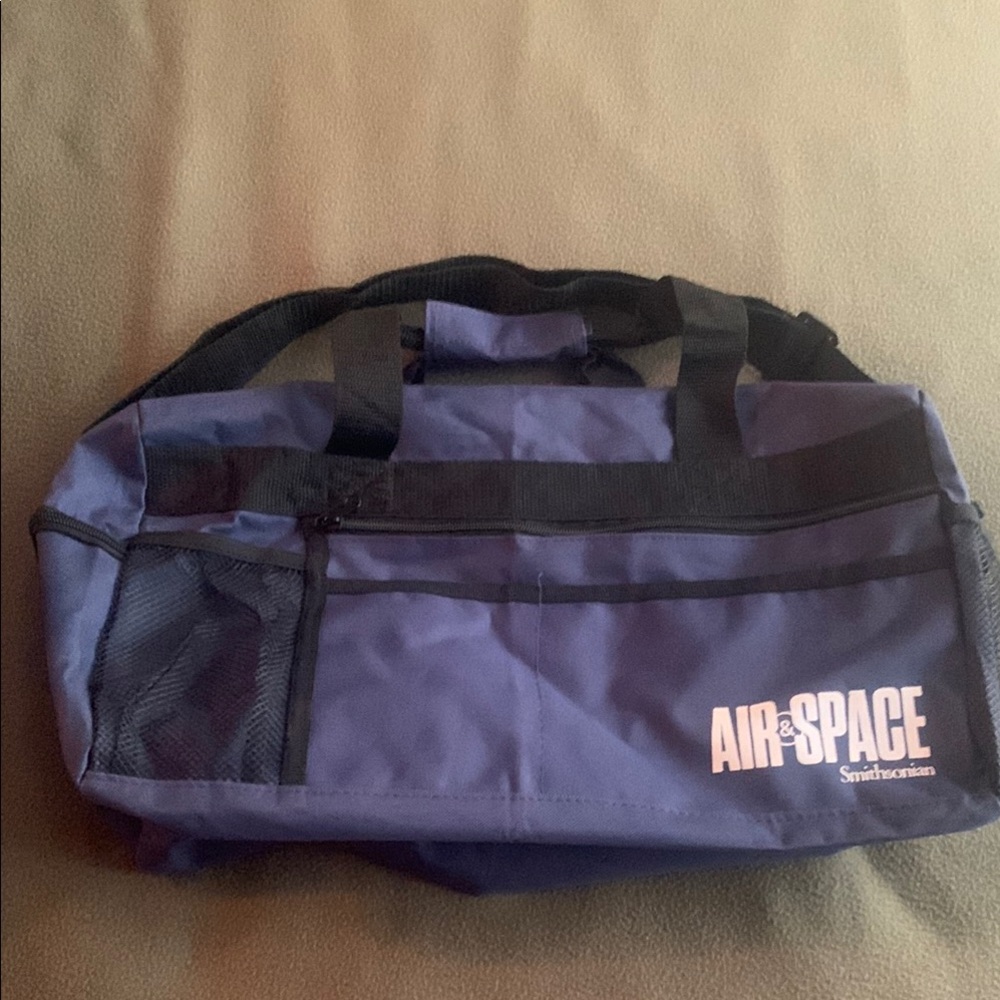 Smithsonian Air & Space blue and black duffel bag. Approx 17” x 9” x 7 1/4”